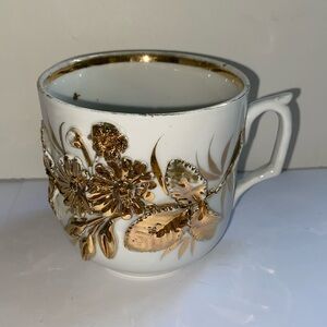 Vintage porcelain mug with 3 dimensional decorative gold flowers